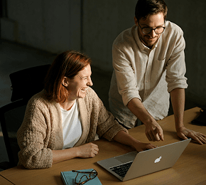Woman and man reviewing data on a laptop